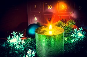 Advent wreath in candles with snow as background and advent calendar